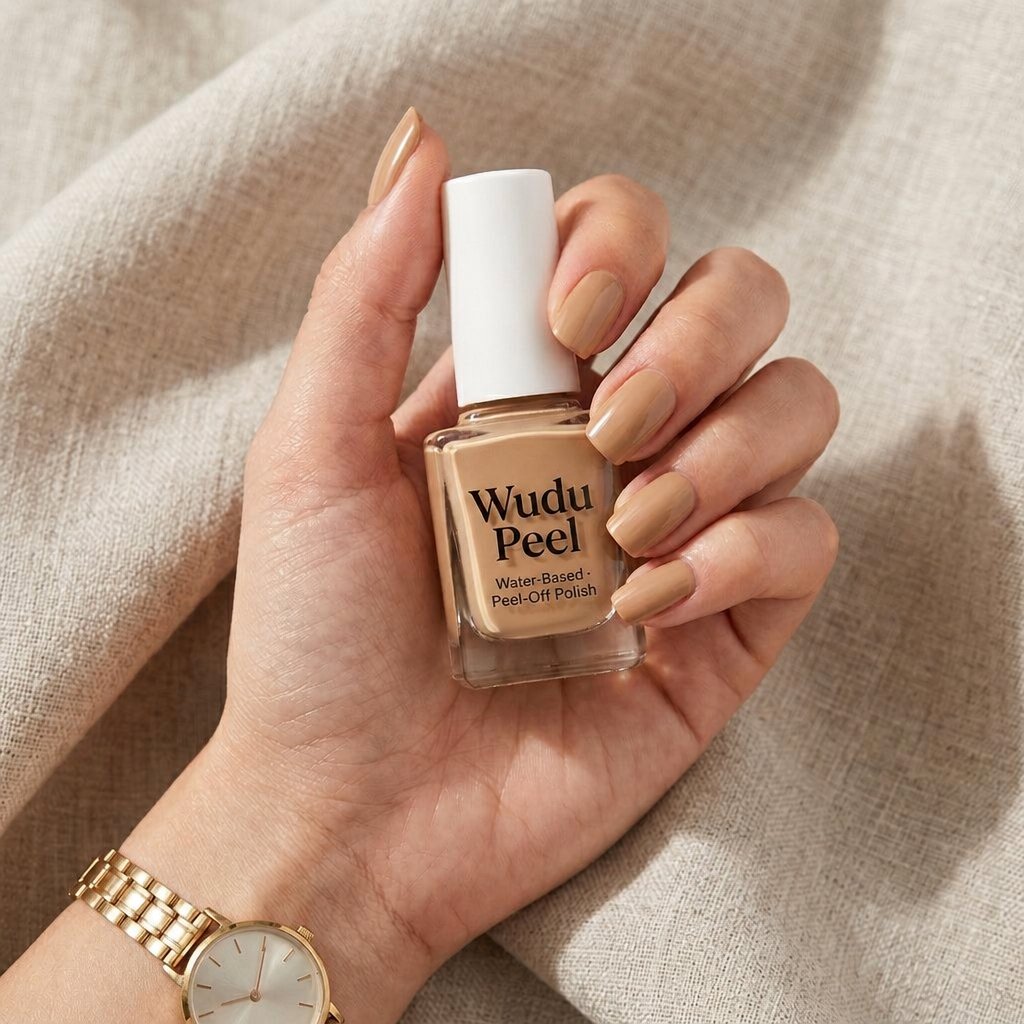 Woman holding a peel-off nail polish bottle in a warm nude shade