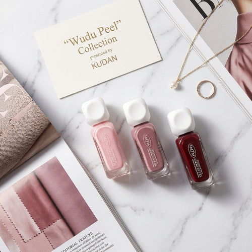 Peel-off nail polish trio flat lay with jewelry and magazine